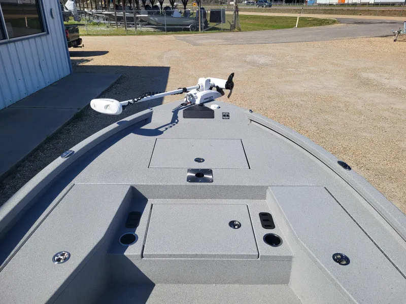 Slide: The Image of 2025 Vexus ACX 2000 boat deck with trolling motor, parked outdoors. - 15