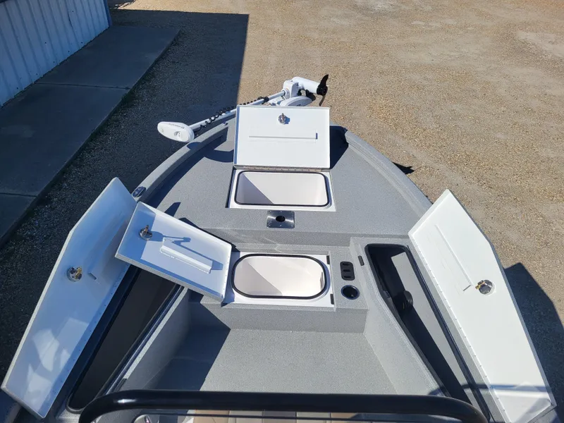 Slide: The Image of 2025 Vexus ACX 2000 boat deck with open storage compartments and trolling motor. - 17