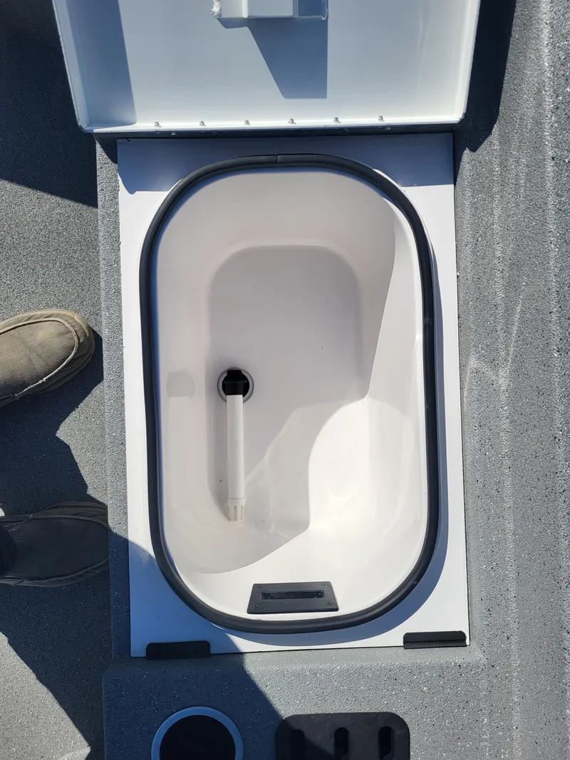 Slide: The Image of Open storage compartment in 2025 Vexus ACX 2000 boat, featuring a clean, white interior. - 19