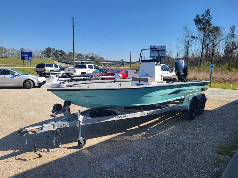 Slide: The Image of 2025 Vexus ACX 2000 boat on trailer in parking lot, sunny day. - 2