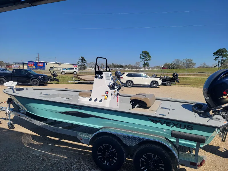 Slide: The Image of 2025 Vexus ACX 2000 boat on trailer, parked outdoors under clear blue sky. - 3