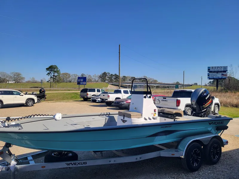 Slide: The Image of 2025 Vexus ACX 2000 boat on trailer in parking lot, clear blue sky. - 6