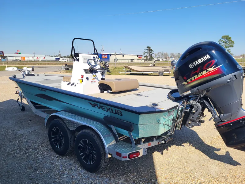 Slide: The Image of 2025 Vexus ACX 2000 boat with Yamaha engine on a trailer, parked outdoors. - 7