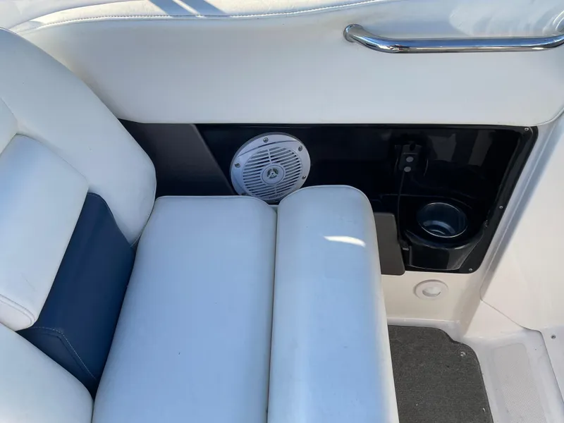 Slide: The Image of 2008 Regal 2700 Bowrider interior with white seating, speaker, and cup holder. - 11