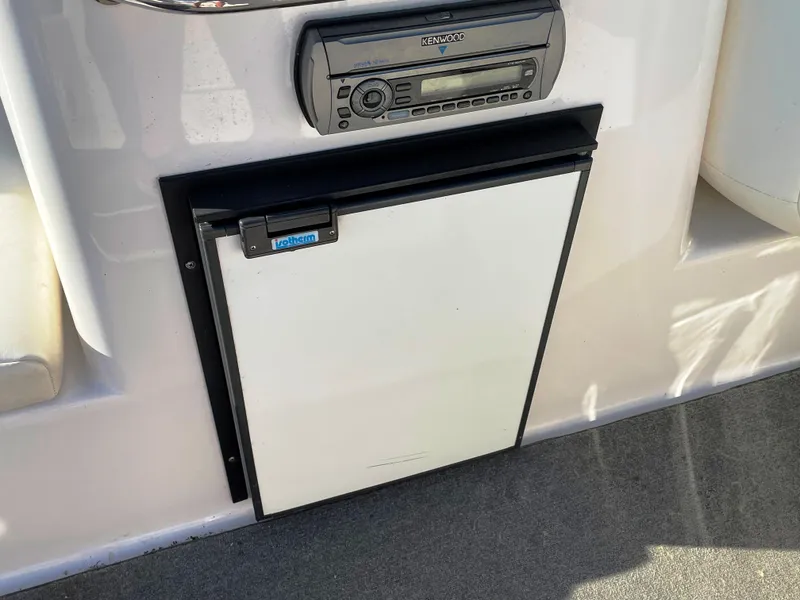 Slide: The Image of 2008 Regal 2700 Bowrider boat interior with stereo and mini fridge. - 12