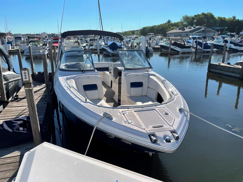 Slide: The Image of 2008 Regal 2700 Bowrider boat docked at a marina, surrounded by other boats. - 2