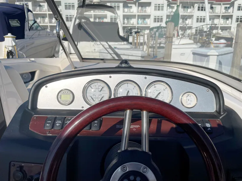 Slide: The Image of Dashboard of a 2008 Regal 2700 Bowrider boat at a marina. - 6