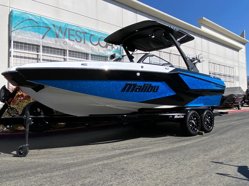 Slide: The Image of 2025 Malibu Wakesetter 23 MXZ boat in blue and black at West Coast Boat Center. - 1