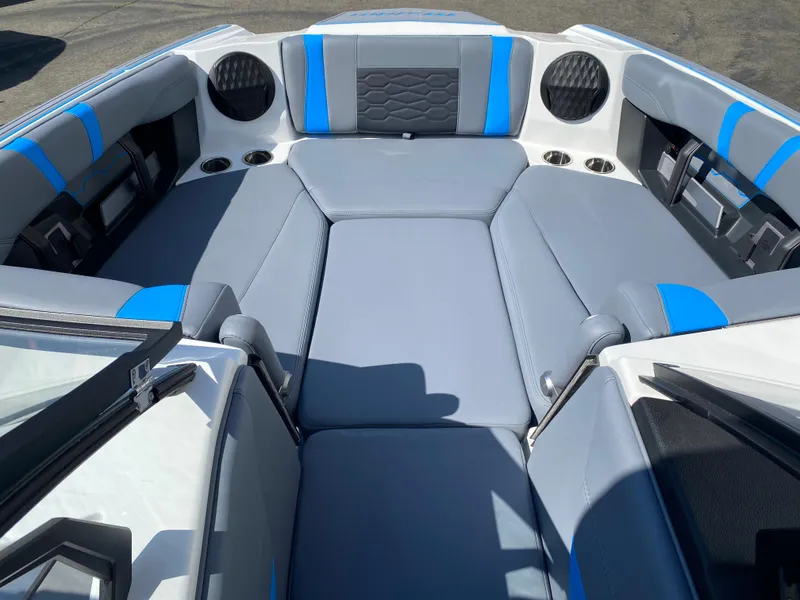 Slide: The Image of 2025 Malibu Wakesetter 23 MXZ interior with gray and blue seating. - 11