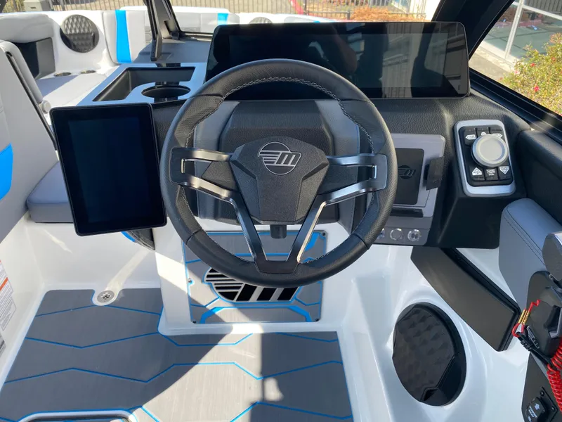 Slide: The Image of 2025 Malibu Wakesetter 23 MXZ boat dashboard with modern steering and digital controls. - 16