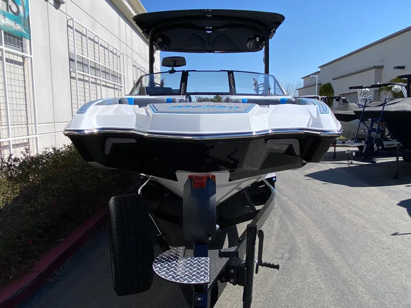 Slide: The Image of 2025 Malibu Wakesetter 23 MXZ boat on trailer, front view, outdoors. - 5
