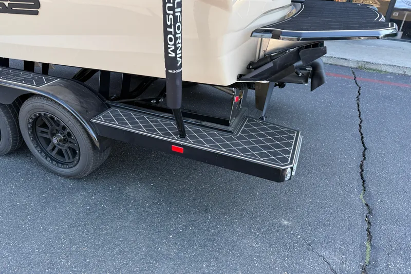Slide: The Image of 2025 MB B52 21 Alpha boat trailer with custom step and black wheels. - 12