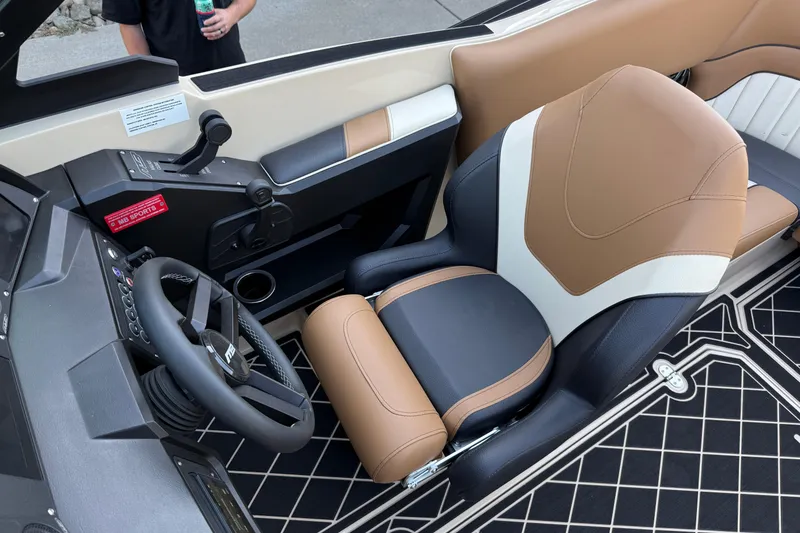 Slide: The Image of 2025 MB B52 21 Alpha boat interior with tan and black seating, steering wheel, and control panel. - 15