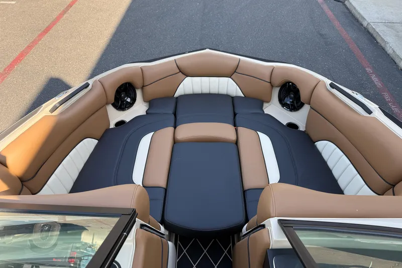 Slide: The Image of 2025 MB B52 21 Alpha boat interior with tan and white cushioned seating. - 23