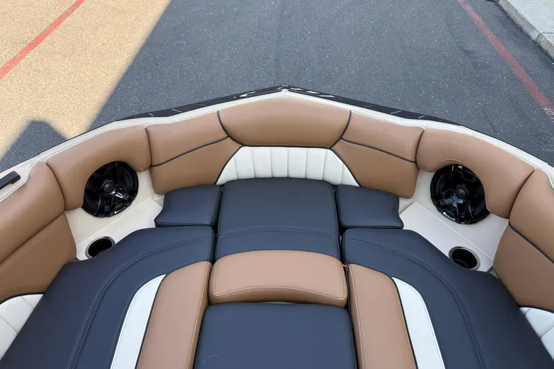 Slide: The Image of 2025 MB B52 21 Alpha boat interior with tan and black seating, featuring built-in speakers. - 25
