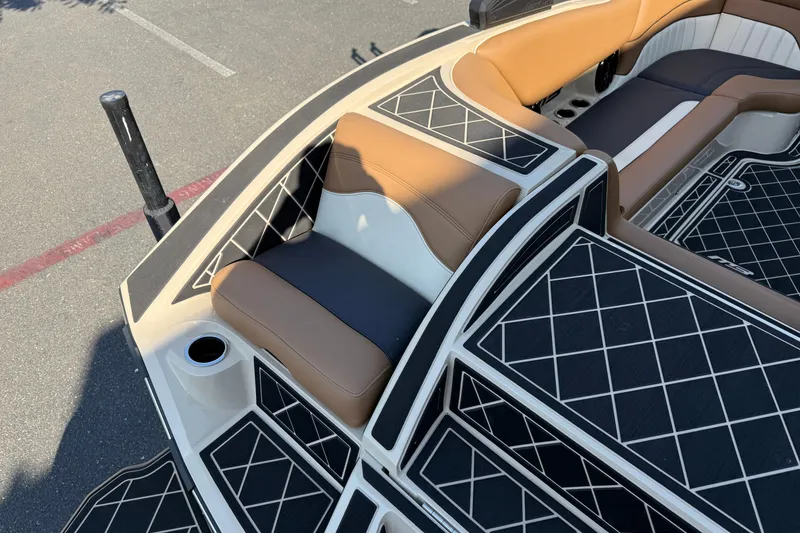 Slide: The Image of 2025 MB B52 21 Alpha boat interior with tan and black seating, diamond-patterned flooring. - 29