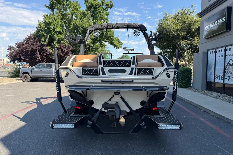 Slide: The Image of 2025 MB B52 21 Alpha boat parked outdoors, showcasing rear design and features. - 6