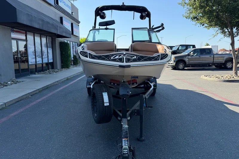 Slide: The Image of 2025 MB B52 21 Alpha boat on trailer in parking lot, front view. - 9
