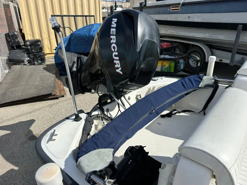 Slide: The Image of 2008 Boston Whaler 130 Sport with Mercury outboard motor, docked outdoors. - 11