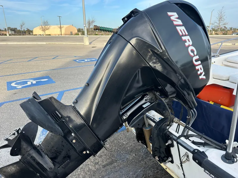 Slide: The Image of 2008 Boston Whaler 130 Sport with Mercury outboard motor in a parking lot. - 6