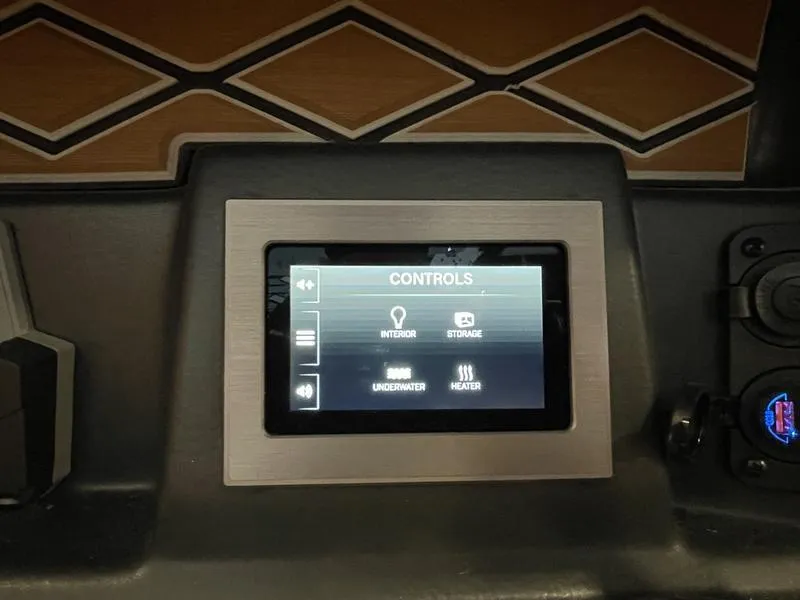 Slide: The Image of 2025 Malibu M230 control panel with touchscreen interface for interior and underwater settings. - 13