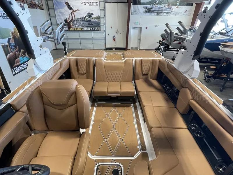 Slide: The Image of 2025 Malibu M230 boat interior with luxurious tan seating and modern design. - 19