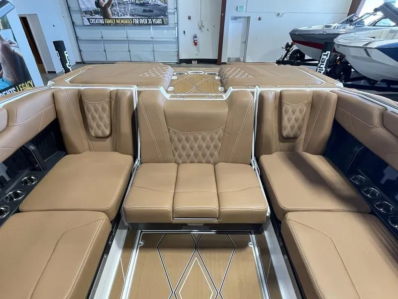 Slide: The Image of 2025 Malibu M230 boat interior with luxurious tan seating and modern design. - 21
