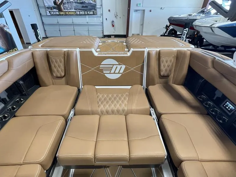 Slide: The Image of Luxurious interior of 2025 Malibu M230 boat with tan leather seating. - 22