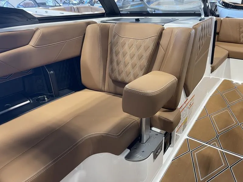 Slide: The Image of 2025 Malibu M230 boat interior with luxurious brown leather seating and diamond stitching. - 24