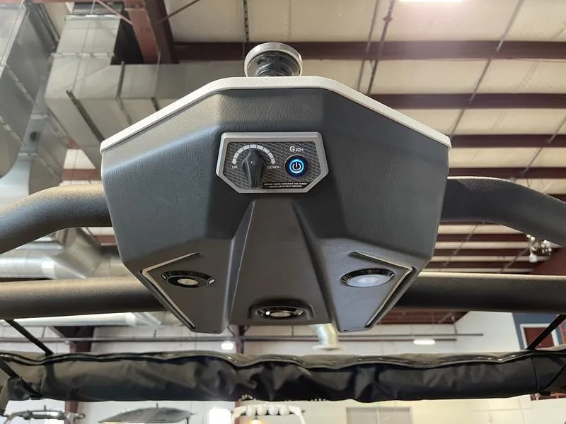 Slide: The Image of 2025 Malibu M230 boat control panel with speakers in a warehouse setting. - 25