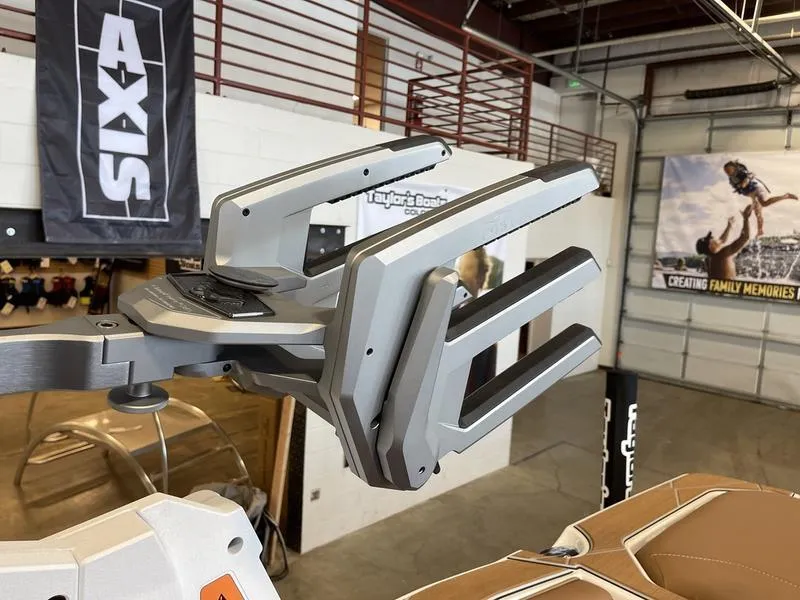 Slide: The Image of 2025 Malibu M230 boat accessory in showroom, featuring sleek metallic design and modern architecture. - 27