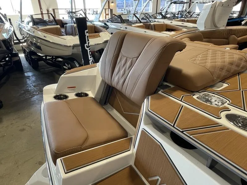 Slide: The Image of 2025 Malibu M230 boat interior with luxurious brown seating and modern design. - 32
