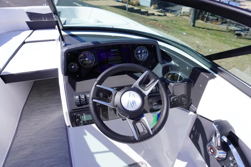 Slide: The Image of 2025 Monterey M22 boat cockpit with steering wheel and dashboard controls. - 14