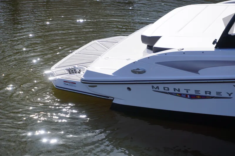 Slide: The Image of 2025 Monterey M22 boat on water, rear view with sunlight reflections. - 4