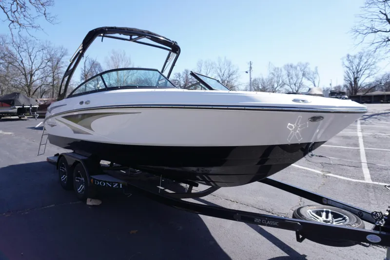 Slide: The Image of 2025 Monterey M22 boat on trailer in parking lot, clear sky background. - 7