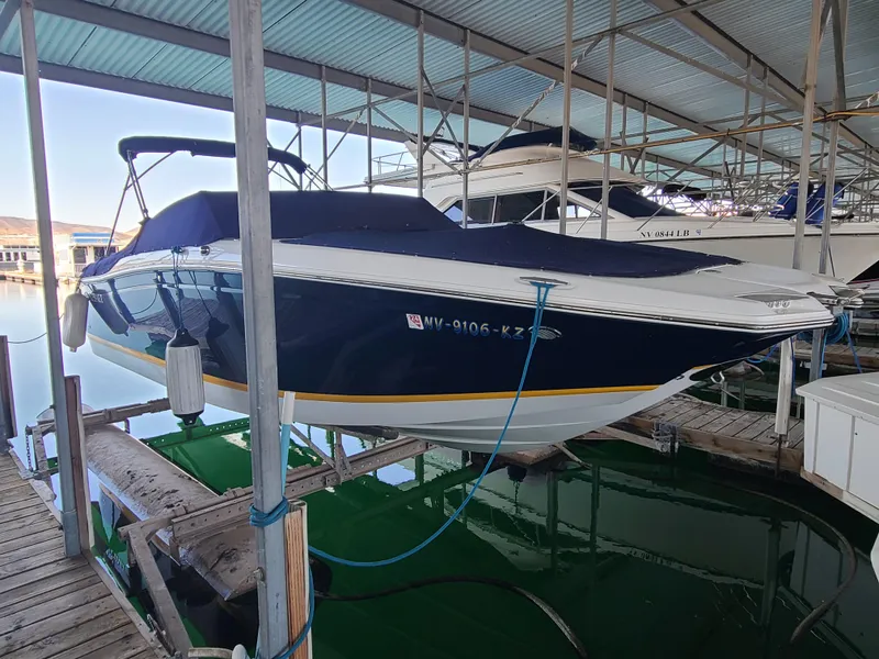 Slide: The Image of 2013 Cobalt 262 Open boat docked in a covered marina. - 3