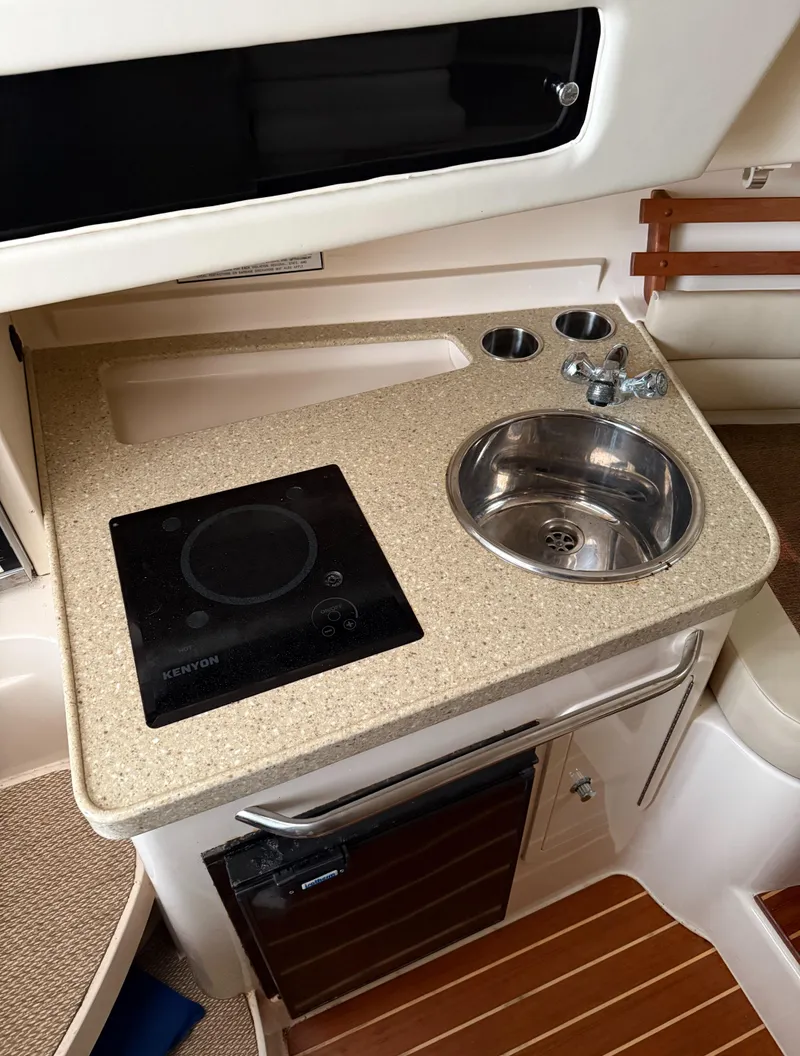 Slide: The Image of 2013 Grady-White Marlin 300 boat kitchenette with sink and stove. - 5