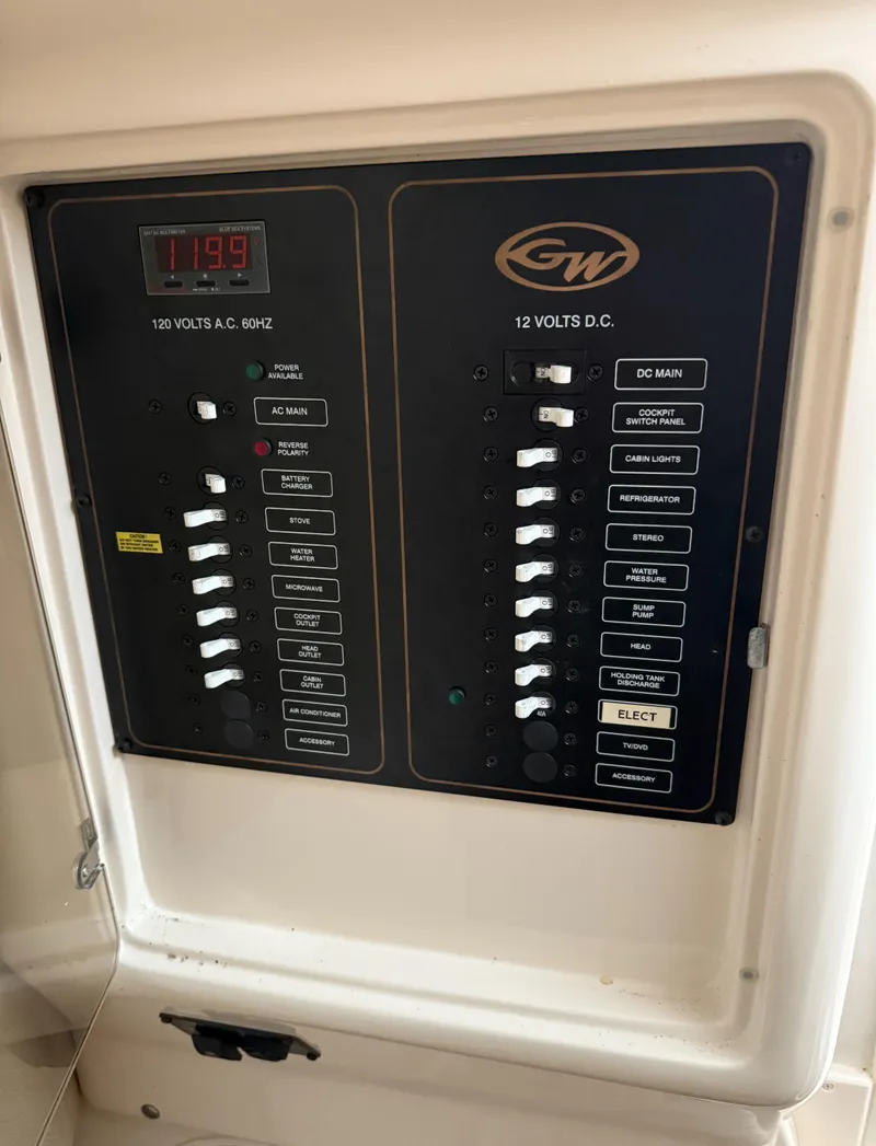 Slide: The Image of Control panel of a 2013 Grady-White Marlin 300 boat, showing voltage and switch controls. - 6
