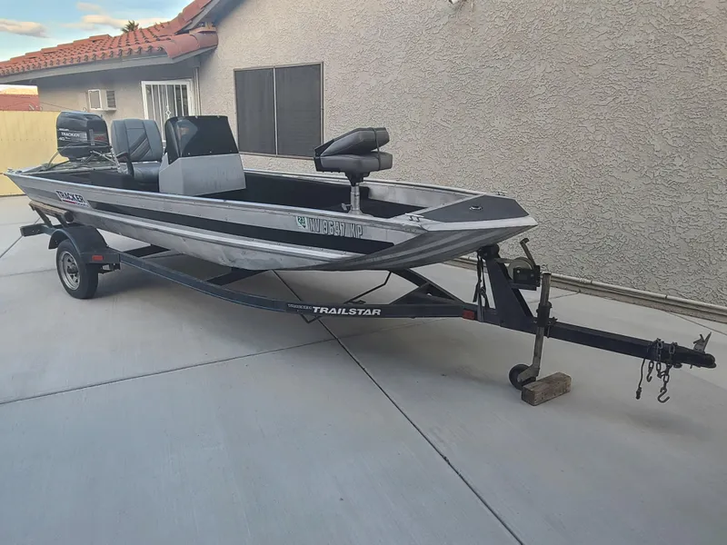 Slide: The Image of 1995 Tracker Open boat on a Trailstar trailer parked in a driveway. - 3