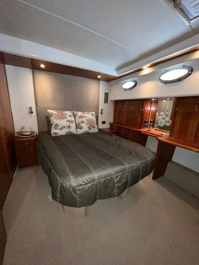 Slide: The Image of Luxurious bedroom in 2007 Maritimo M60 yacht with elegant wood finishes and cozy bedding. - 13