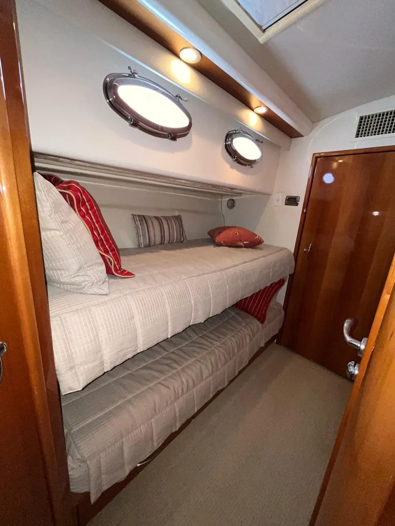 Slide: The Image of 2007 Maritimo M60 yacht cabin with bunk beds and portholes. - 15