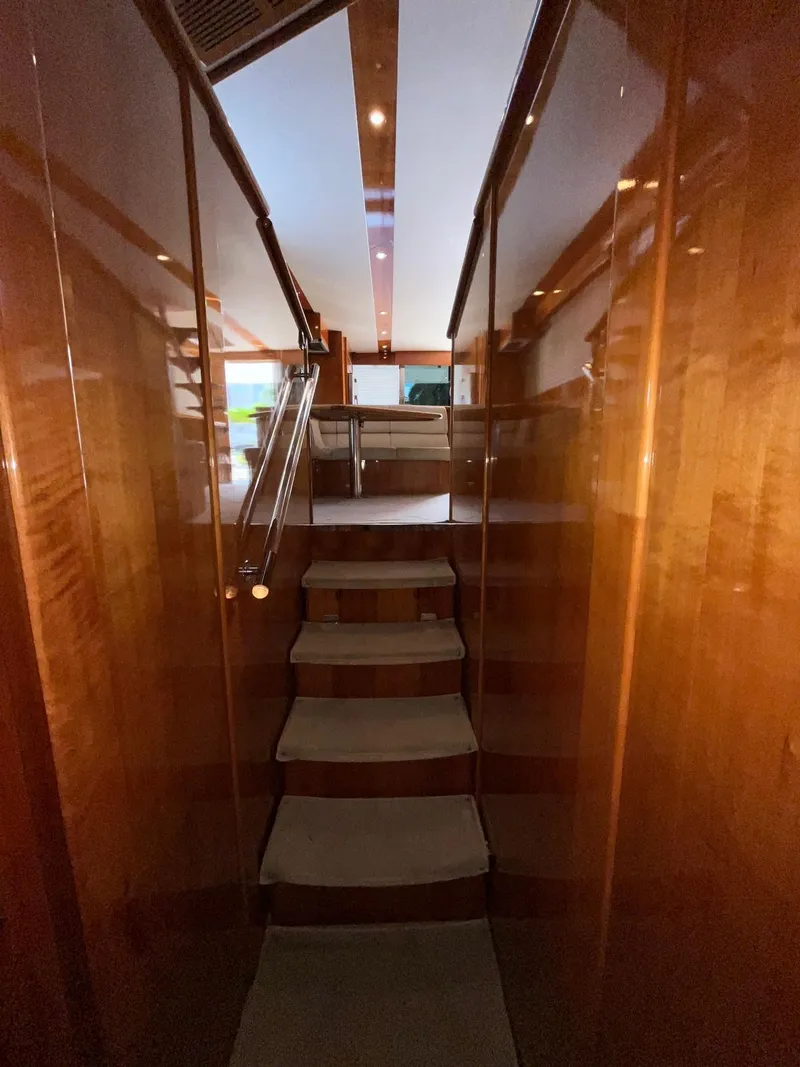 Slide: The Image of Interior view of 2007 Maritimo M60 yacht with polished wood and carpeted stairs. - 16