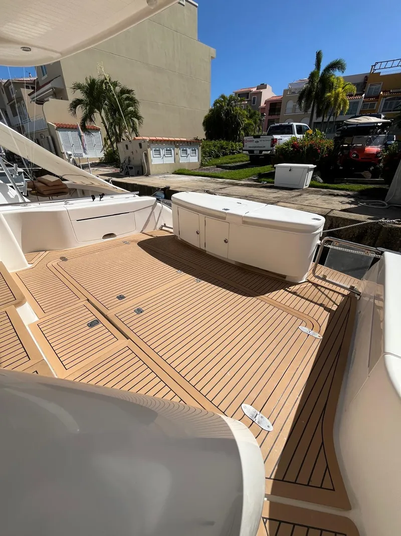 Slide: The Image of 2007 Maritimo M60 yacht deck with teak flooring, docked in a sunny marina. - 3