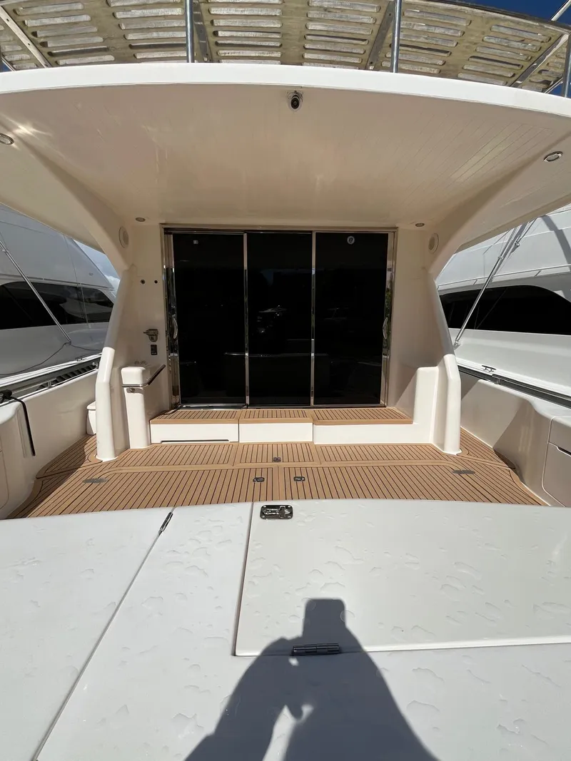 Slide: The Image of 2007 Maritimo M60 yacht deck with sliding glass doors and spacious seating area. - 7