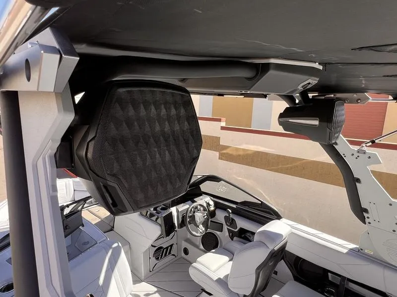 Slide: The Image of Interior of 2025 Malibu 23 LSV boat with advanced audio system and sleek design. - 12