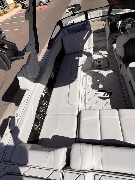 Slide: The Image of 2025 Malibu 23 LSV boat interior with luxurious seating and modern design. - 16