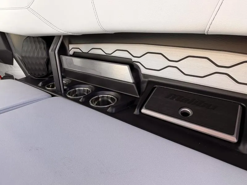 Slide: The Image of Interior of 2025 Malibu 23 LSV boat with cup holders and sleek design. - 21