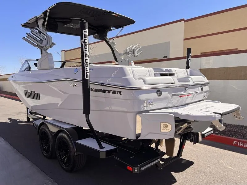 Slide: The Image of 2025 Malibu 23 LSV boat on trailer, sleek design, outdoor setting. - 4