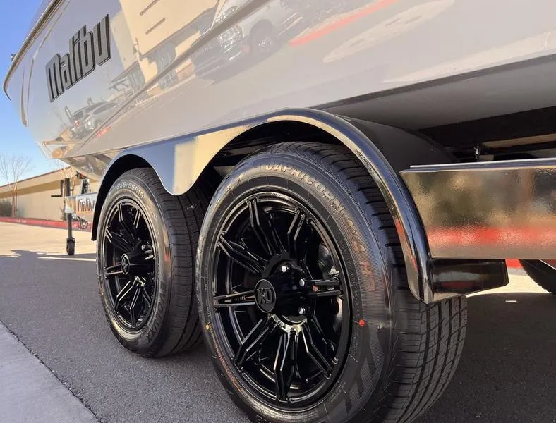 Slide: The Image of 2025 Malibu 23 LSV boat trailer with sleek black wheels. - 7