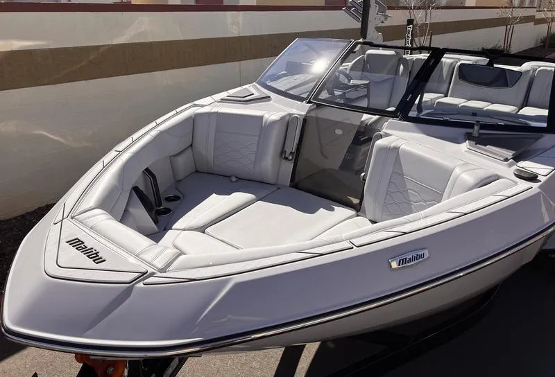 Slide: The Image of 2025 Malibu 23 LSV boat with sleek white interior and modern design. - 9